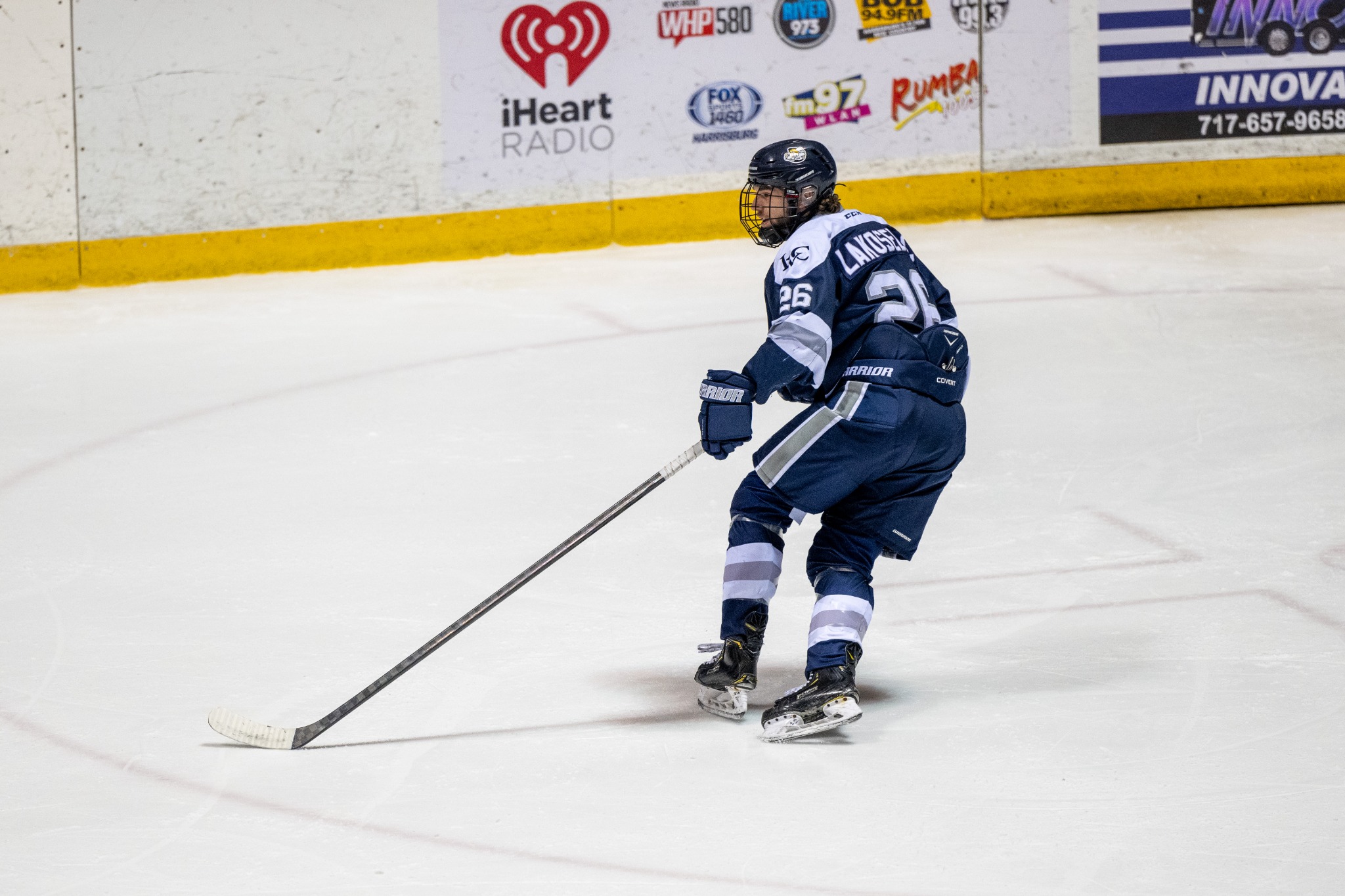 Stefan Lakoseljac skating in his navy college hockey uniform