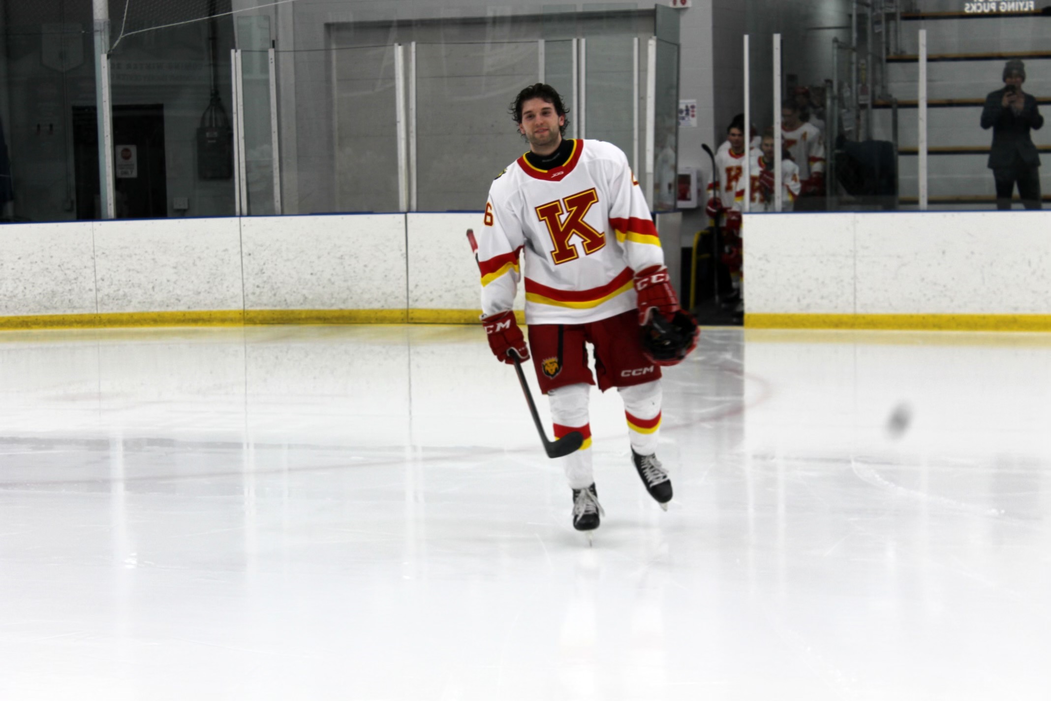 Stefan Lakoseljac skating in his college hockey uniform